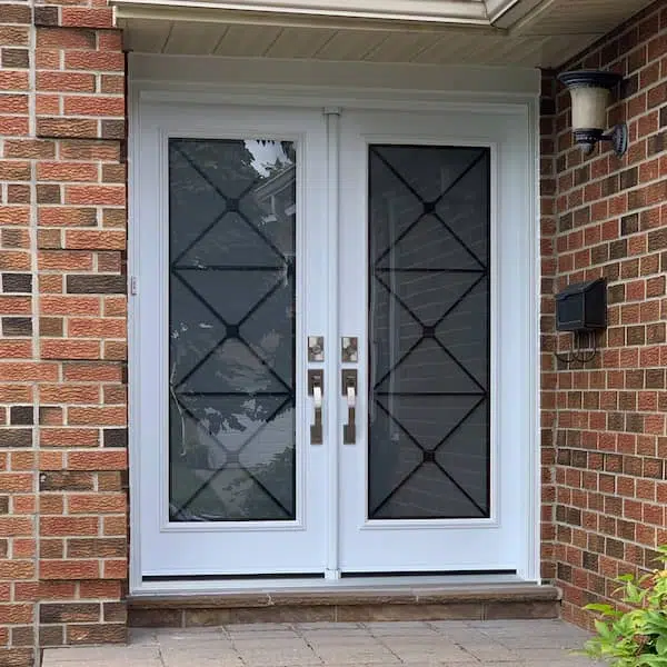 Modern double front entry door system with full-length vertical glass inserts