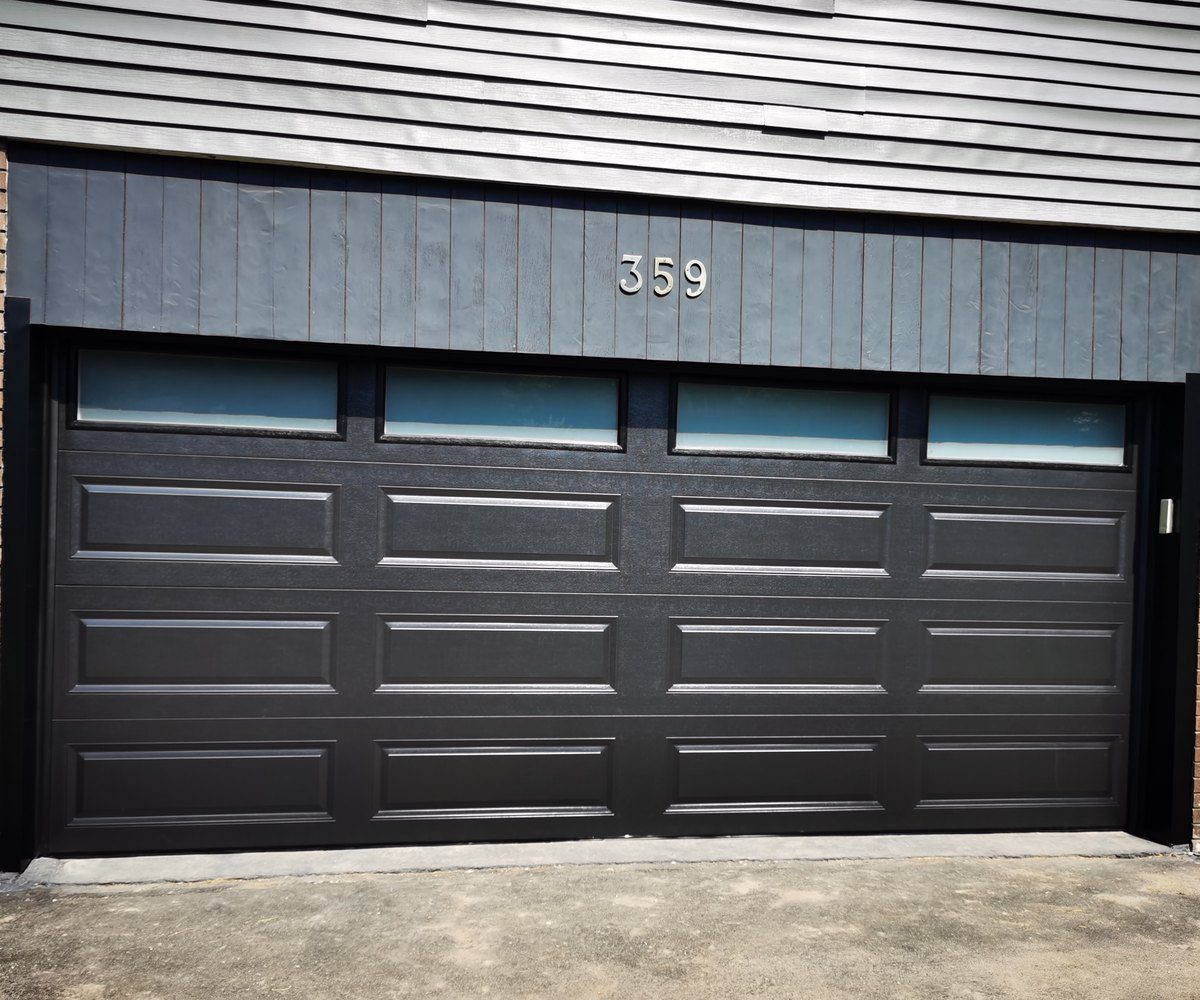 Architectural cedar-finish insulated steel garage doors with heavy-duty weatherstrip