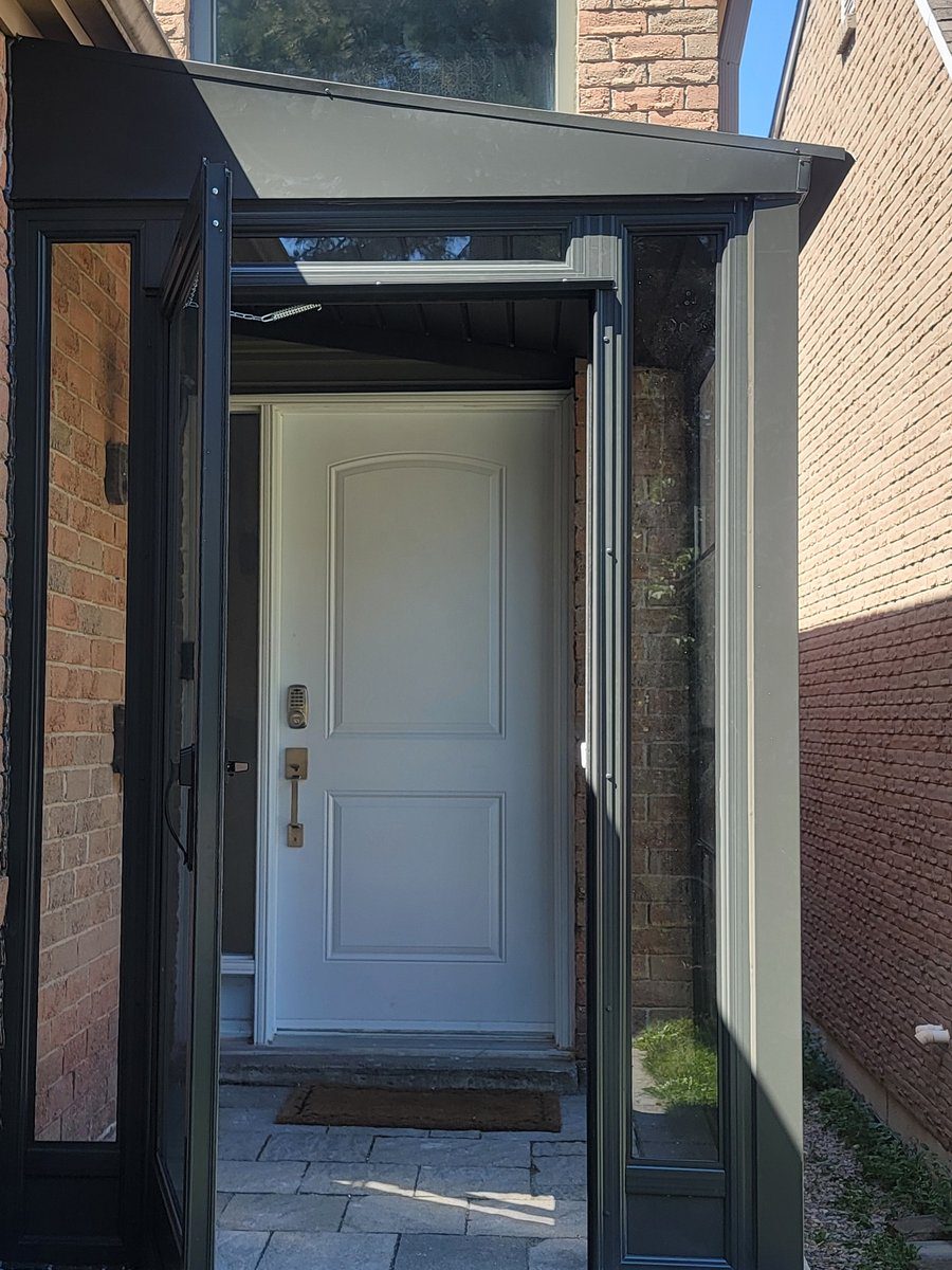 Heavy-duty black architectural aluminum glass porch enclosure with integrated locking entry door