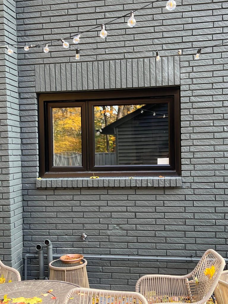 Contemporary charcoal high-efficiency triple pane casement windows on brick exterior