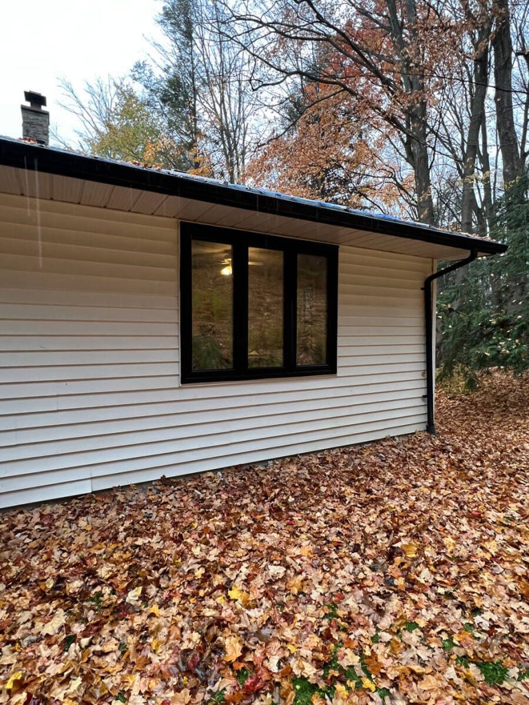 Modern black thermal-frame casement windows installed on residential horizontal siding