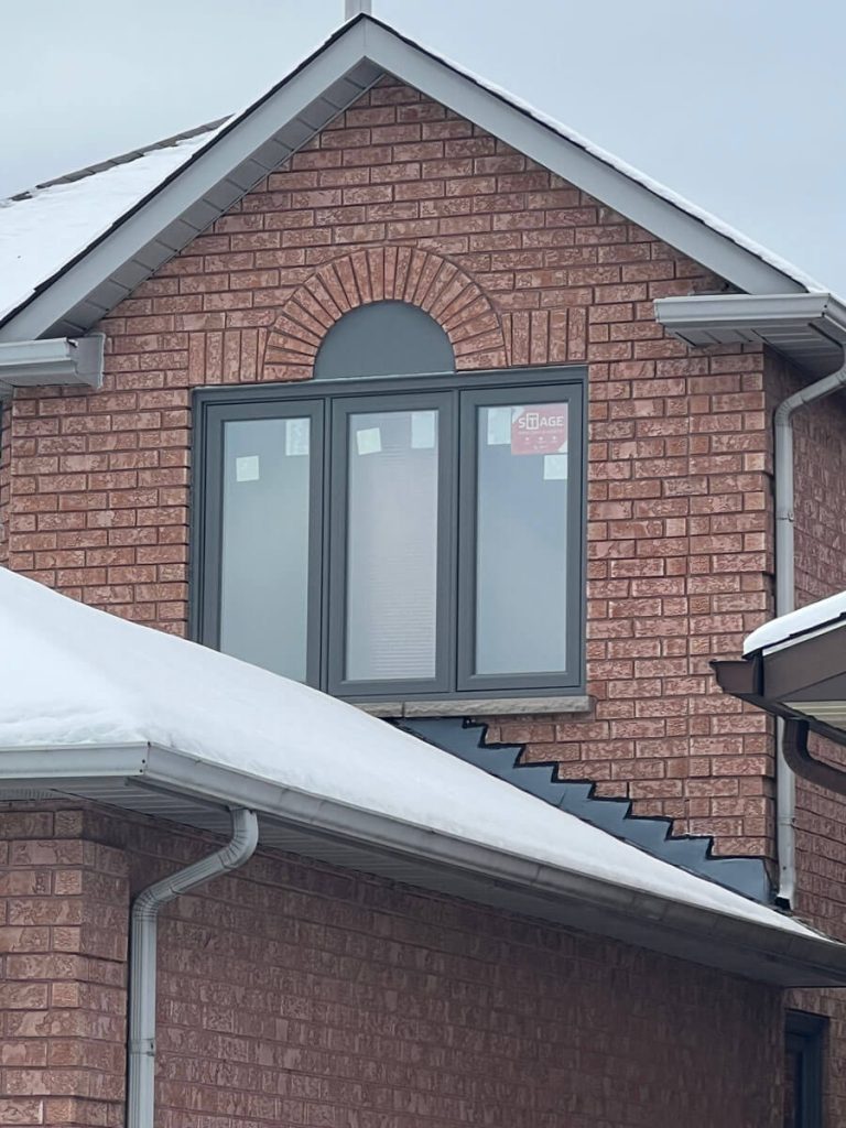 Second-story architectural arched gable triple-casement window replacement