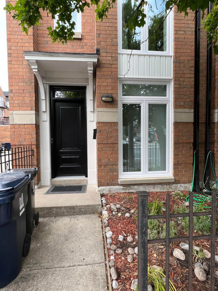 Townhome front facade large picture window and architectural black entry transom