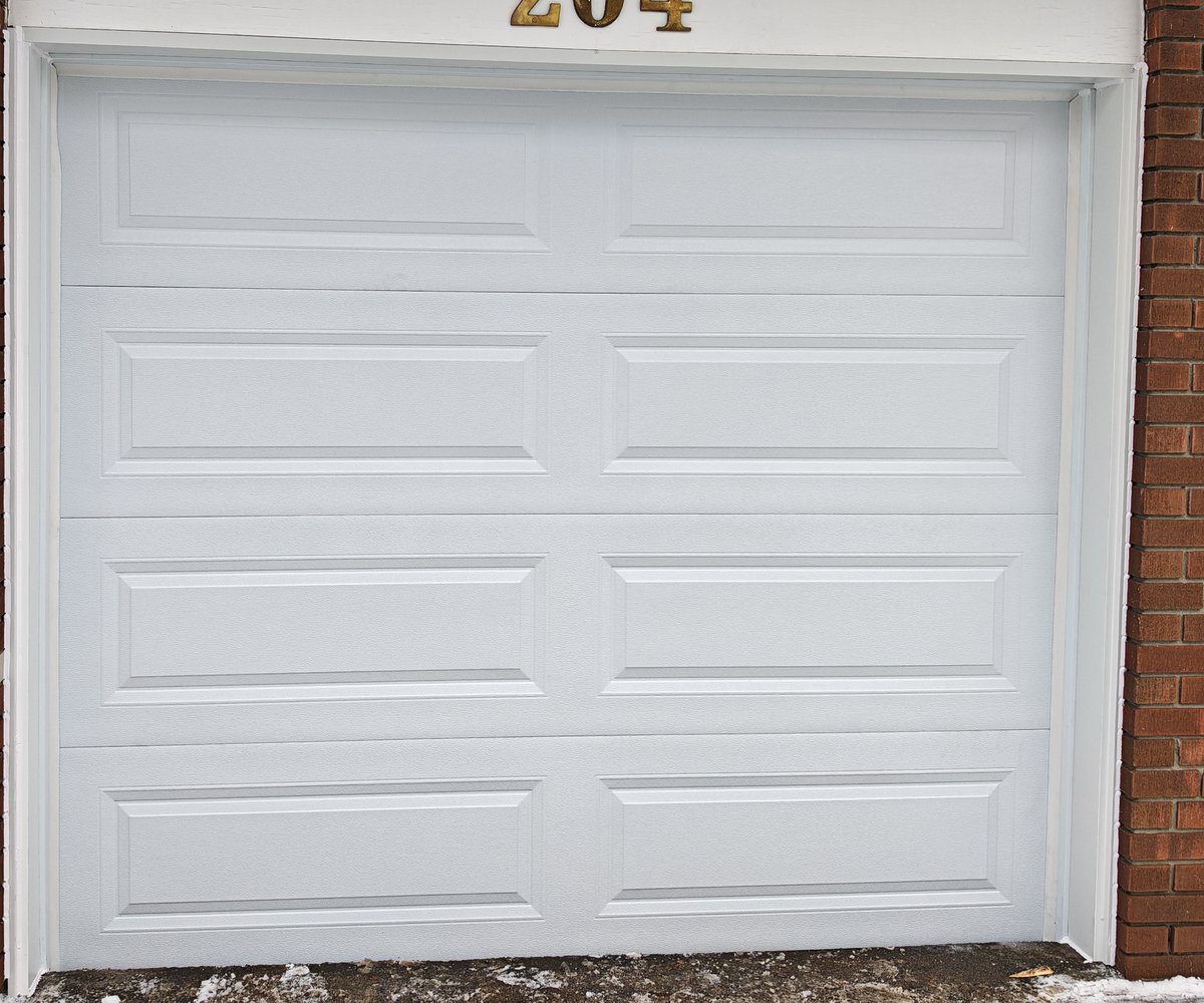 New white raised-panel garage door after replacement on a Vaughan home